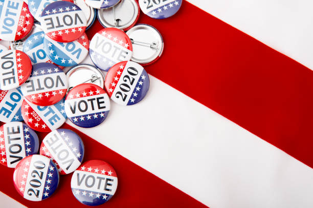 istock Elections 2020 patriotic pins on US flag background 1256669339