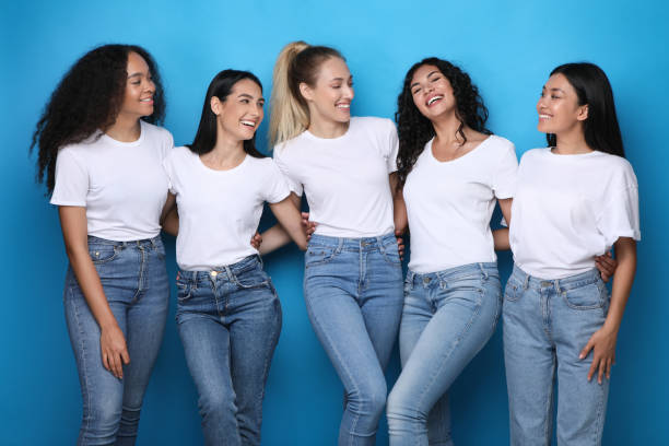 istock Diverse Young Women Embracing Smiling Each Other Over Blue Background 1256670037