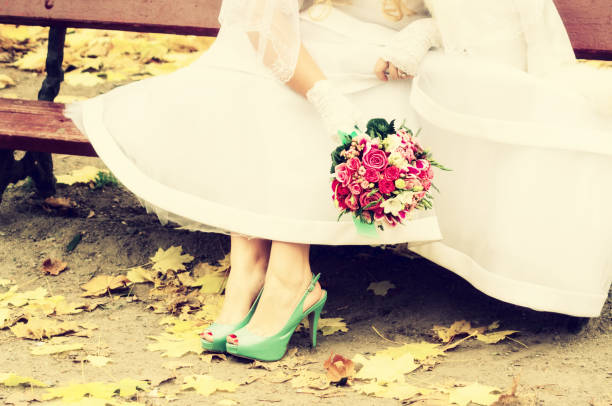 istock Bride in bright clothes on the bench 1256670636