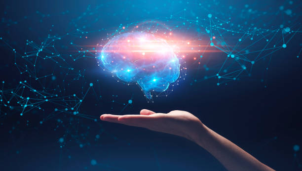 istock Hand holding shining brain over galaxy background 1256674469