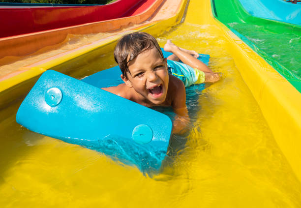 istock A boy is having fun on water slide 1256674529