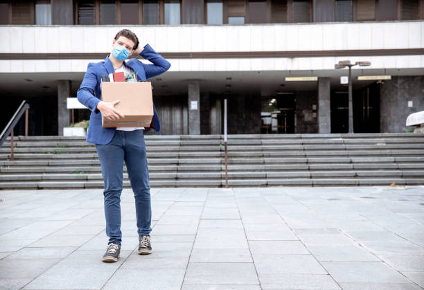 istock Dismissed millenial leaving office building 1256676472