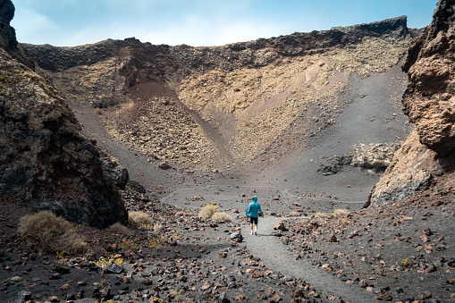 Lanzarote Travel. Young man visiting Timanfaya National Park. Canary Islands. Trekking