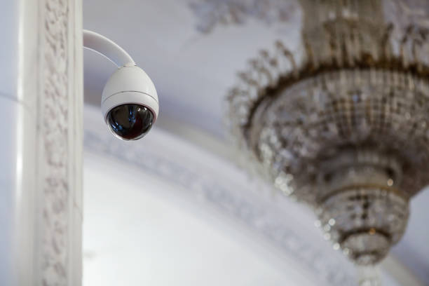 istock Shallow depth of field (selective focus) image with a cctv camera inside a big official building. 1256677735