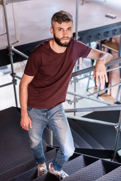 istock businessman standing on stairs in modern office 1256678241