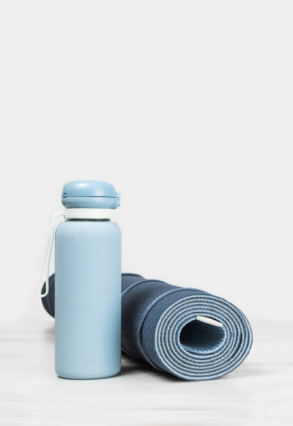 istock Rolled yoga mat and blue water bottle 1256678550