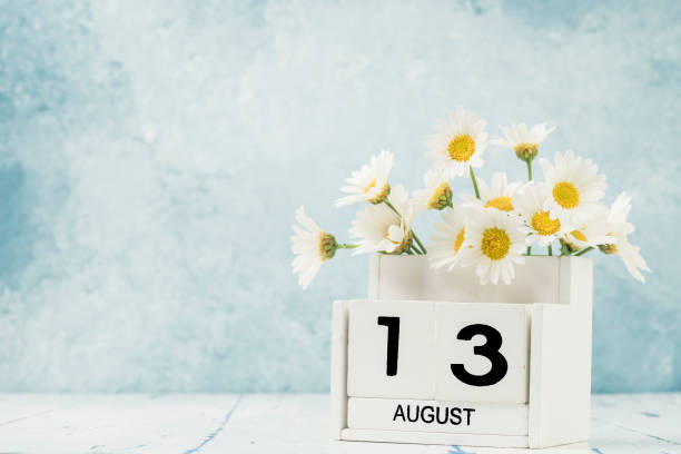 istock White cube calendar for august decorated with daisy flowers 1256680277