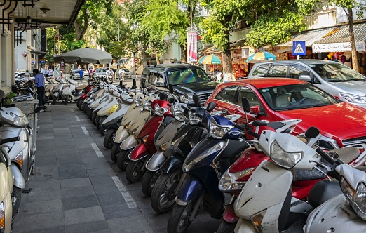 Hanoi, Vietnam, November 24, 2014: Motorcycles are the most common means of transportation in the Vietnamese capital. View of a street in the downtown of Hanoi.