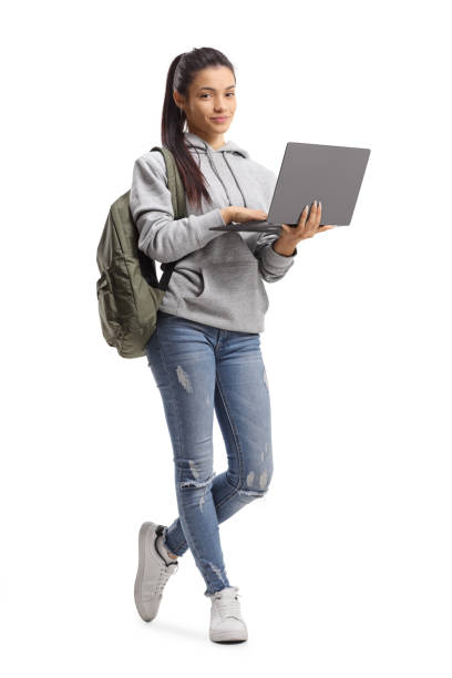 istock Female student standing with a laptop computer and looking at the camera 1256682772