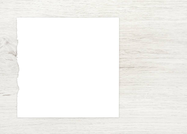 istock White paper sheet on wood. 1256684953