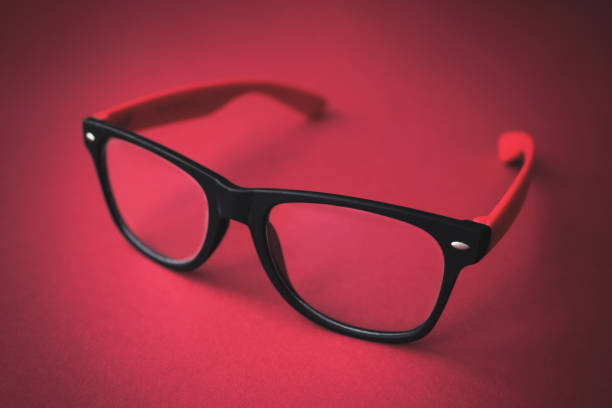 istock Beautiful Glasses on red background. Close-up. Eyecare concept. 1256686174