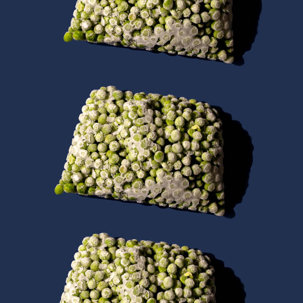 Pattern of frozen green pea on blue background