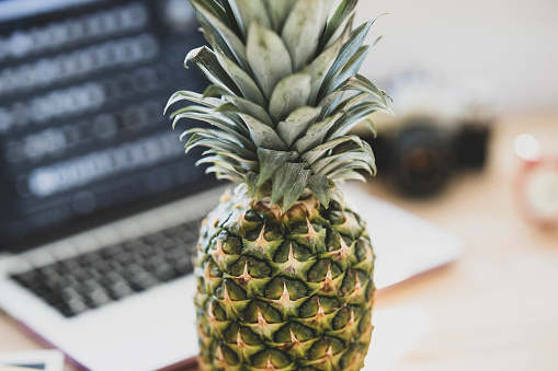 a desk in the office and pineapple on it
