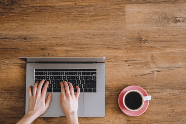 Female hands are typing on laptop keyboard.