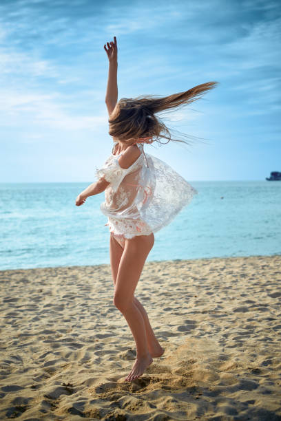 istock Happy woman having fun in summer day on beach 1256692536