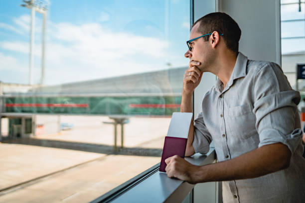istock Man on airport waiting for a flight 1256697371