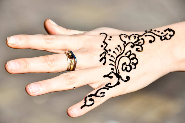istock tatoo henna and hand with ring, photo as background 1256697619