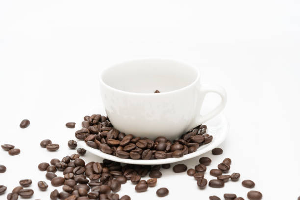 istock Coffee beans and white coffee cup isolated on white. 1256698096