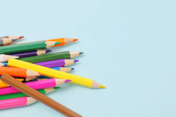 istock Colorful colored pencils on a blue background 1256701019
