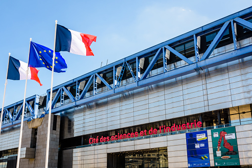 Paris, France - June 22, 2020: Low angle view of the facade and sign of the Cite des Sciences et de l'Industrie, the largest science museum in Europe, located in the Parc de la Villette.