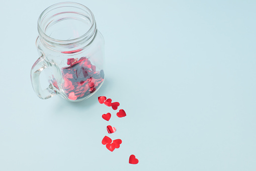 Numerous red hearts with glass bottles with blue backgrounds