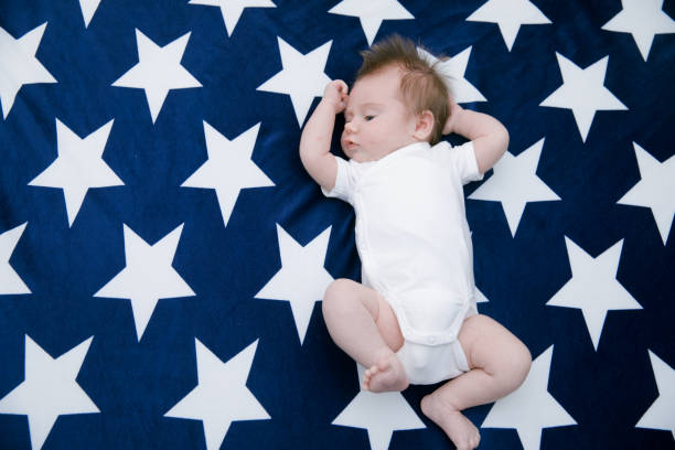 istock Small cute funny baby infant teething with face expression 1256704055