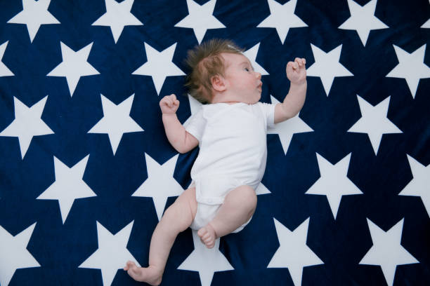 istock Small cute funny baby infant teething with face expression 1256704634