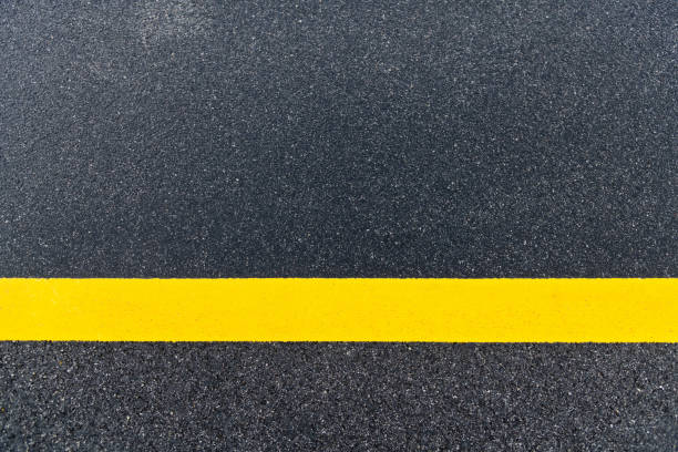 istock Asphalt road with single yellow line 1256707371