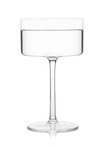 istock Vodka martini gin cocktail in modern glass on white background with reflection. 1256710368