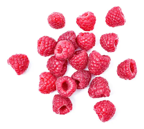 Fresh raspberries, isolated on white background. Arrangement of raspberry fruits, cut out objects, healthy eating theme.