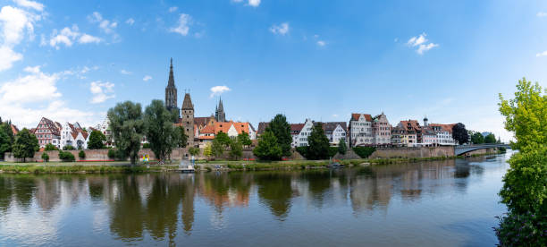panorama view of the city of Ulm in southern Germany with the Danube River in front A panorama view of the city of Ulm in southern Germany with the Danube River in front ulm minster stock pictures, royalty-free photos & images