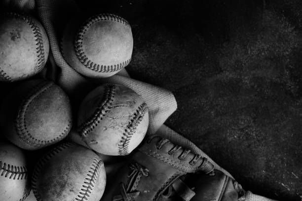 istock Group of old used baseballs in black and white 1256712911