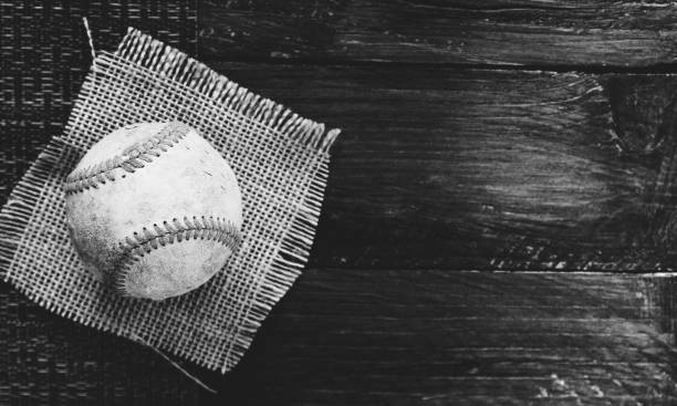 Baseball on wood background with burlap cloth