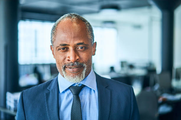 istock Confident mature businessman standing in a modern office 1256714209