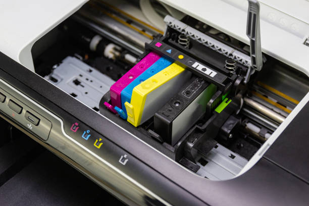 An ink cartridge or inkjet cartridge is a component of an inkjet printer that contains the ink four color stock photo
