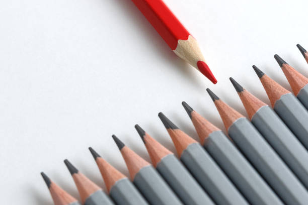istock Support Group, Intervention. Conceptual. Red and gray pencils opposite each other on an isolated background 1256718978