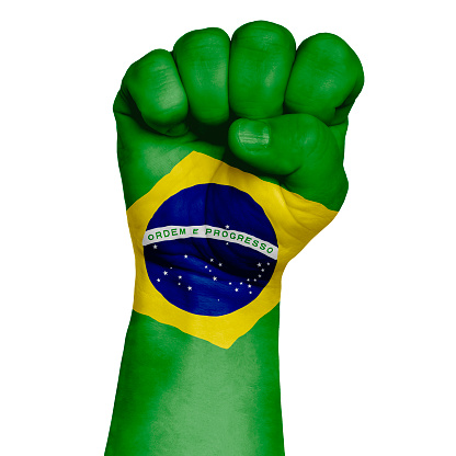 A discreet image of a fist painted in the colors of the flag of Brazil. Image on a white background. Isolate