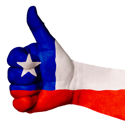 Hand with thumb up gesture in colored chile national flag as symbol of excellence, achievement, good, - for tourism and touristic advertising, positive political, social management of country