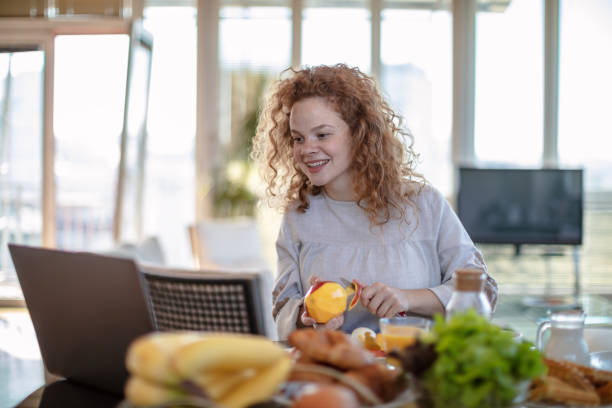 istock Young woman using laptop at home 1256720881