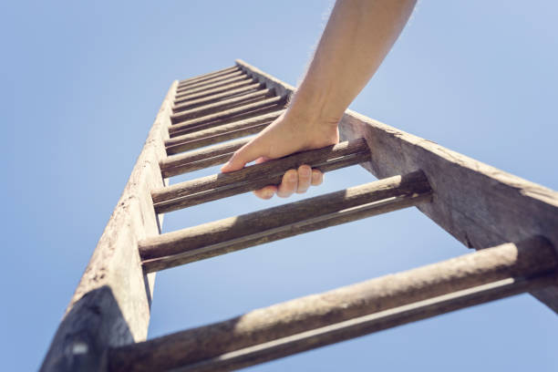 Ladder of success Businessman climbing the corporate ladder of success ladder photos stock pictures, royalty-free photos & images
