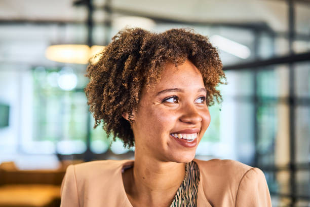 istock Smiling young businesswoman standing in an open plan office 1256722161