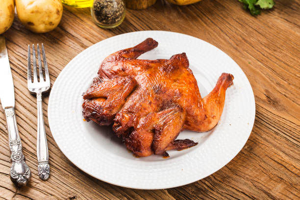 istock Fresh roast chicken on a wooden board background 1256723900