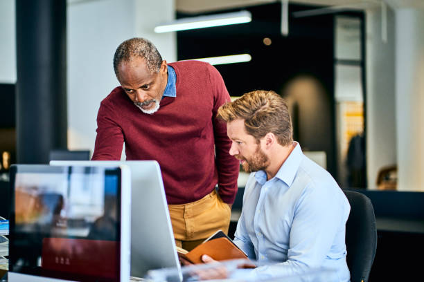 istock Two diverse designers working on a project together in an office 1256723908