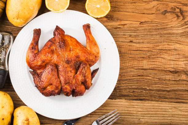 Fresh roast chicken on a wooden board background