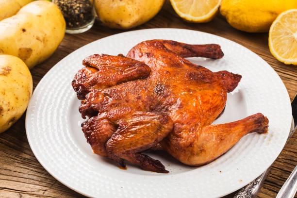 istock Fresh roast chicken on a wooden board background 1256723939