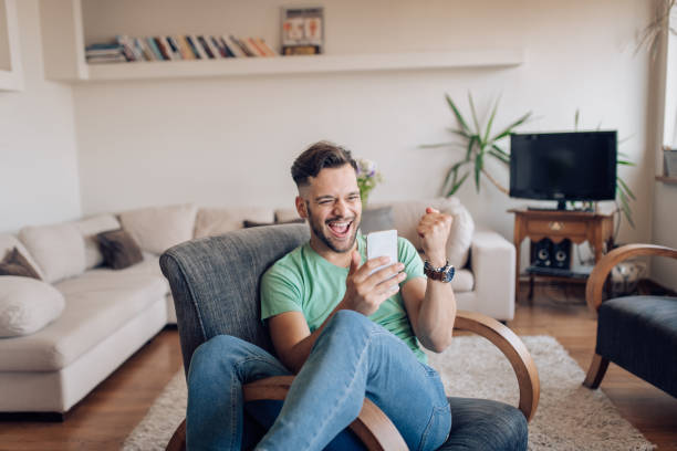 istock Excited man playing a mobile game and cheering 1256724206