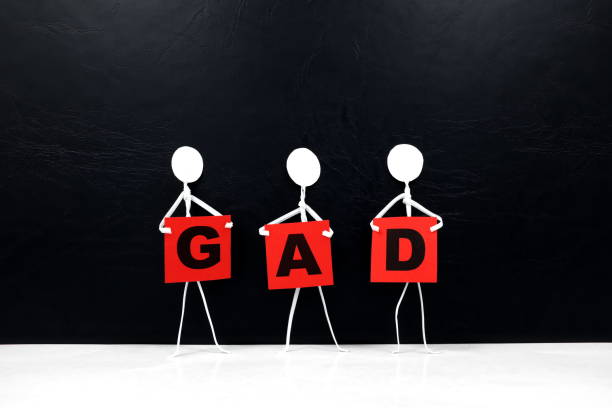 istock Human stick figure holding red GAD or Generalized Anxiety Disorder word banner. Black background. 1256724245