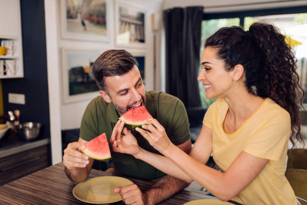 istock Husband and wife sharing watermelon and enjoying 1256725565