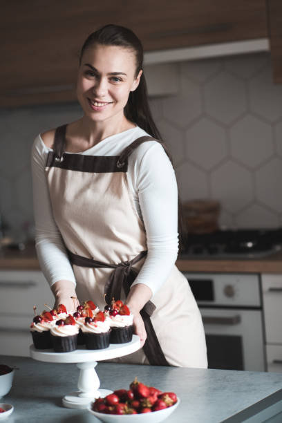 istock Woman cooking cupcakes at home 1256725638