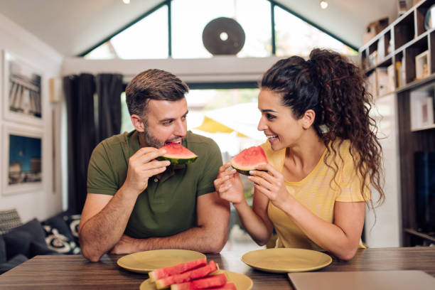 istock Happy couple refreshing with watermelon 1256725682